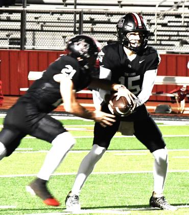 (above) Levelland’s Senior quarterback Ethan Salazar hands the ball to senior running back Jake Potter on Oct. 16 in the 76-53 win over Perryton.