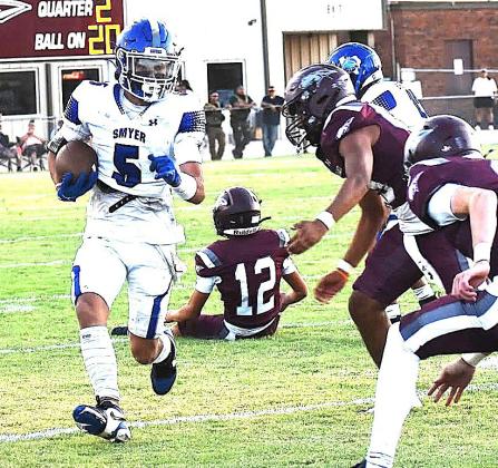Smyer Bobcat Noah Gonzales carries ball in game against the Ralls Jackrabbits during last Friday’s game. (Smyer ISD photo)