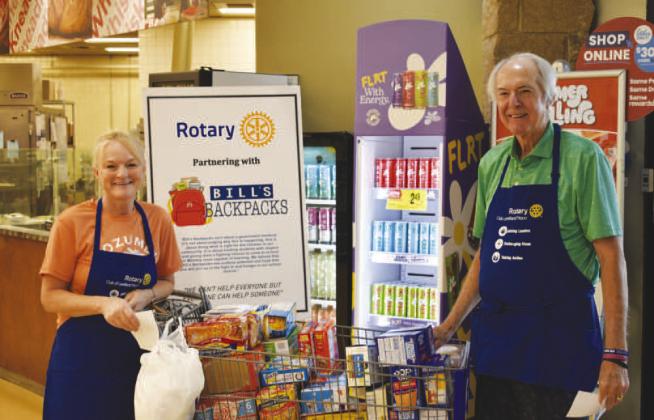 FOOD COLLECTION – Pictured is Phelps Blume and Amber Hinson of the Noon Rotary Club collecting donations for Bill’s Backpacks on Saturday. The club welcomes volunteers who help collect donations on the second Saturday of every month. The club collected $1,322.97 worth of items this past Saturday.They thank eveyone that donated (Staff photo)