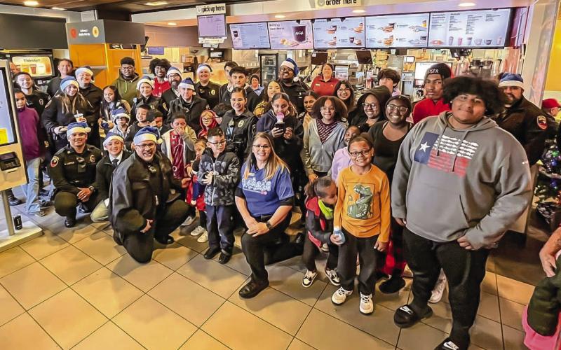 CHRISTMAS SMILES - Kicking off Saturday’s activities for the 2023 Blue Santa event, local law enforcement officers along with 29 children from 17 families enjoyed an early morning breakfast at McDonalds before making their way to Walmart for a little Christmas shopping. Pictured are local law enforcement officers along side the families and McDonalds staff enjoying their Saturday morning. (Photo courtesy of LPD)