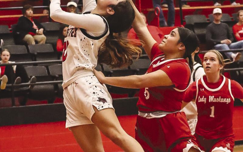 FASTBREAK - Levelland Loboette Carly Tienda layed the ball up through the contact last Tuesday against the Sweetwater Lady Mustangs. (Staff photo by Aalijah Soliz)