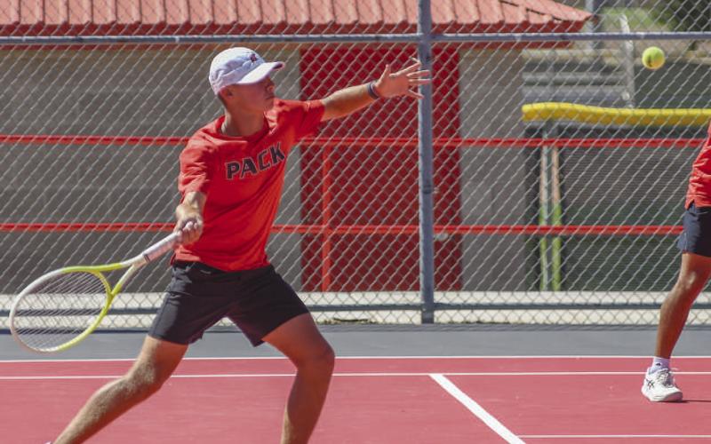 STRONG RETURN - The fall tennis season continues for Lobo Pack Tennis as they competed on the road at Brugess-Rushing Tennis Center Saturday against All Saints. Pictured is Nathan Ellis going through his motion to return a ball during his doubles match against Seminole. (Staff photo by Dom Puente)