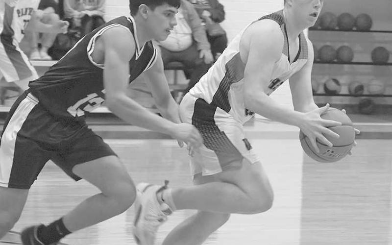 REBOUND AND PUSH- Whitharral’s Jarrett Fryar took a rebound down court against Morton’s Xavier Ramon in a 49-32 home win over the Morton Indians to open UIL Region I, Class 1A-7 boys high school basketball play. Whitharral will be in the Caprock Classic Tournament in Lubbock this weekend while Morton’s next outing will be January 6 at home against Amherst at 8 p.m. (Photo Courtesy of Jay Kelley)
