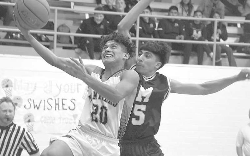 UP AND UNDER- Whitharral’s Nomar Gomez had 10 points in a 49-32 home win over the Morton Indians to open UIL Region I, Class 1A-7 boys high school basketball play. Whitharral will be in the Caprock Classic Tournament in Lubbock this weekend while Morton’s next outing will be January 6 at home against Amherst at 8 p.m. (Photo Courtesy of Jay Kelley)