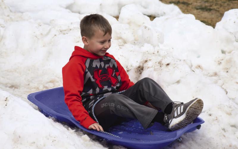 SLIDING INTO THE NEW YEAR - Unsure if the parks department would be able to bring the sled hill to Lobo Lake this year, the department too advantage of the colder temperatures and went to work giving the kids of the community a chance to enjoy some snow this winter season. (Staff Photo)