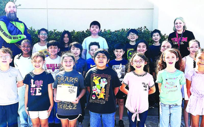 PREMIER MARTIALARTS FIELD TRIP-- LISD Capitol Elementary second and third graders and PE teacher Kristy Sanders recently took a karate field trip to Premier Martial Arts in Lubbock. Students learned about being kind, confident, and disciplined as well as learning a few basic self-defense and karate moves. (Photo courtesy of Kristy Sanders)