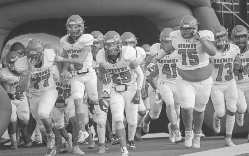 GAMETIME - The Sundown Roughnecks ran out of their tunnel last Thursday before their first game of the season against the Shamrock Fighting Irish in Canyon. (Staff photo by Aalijah Soliz)
