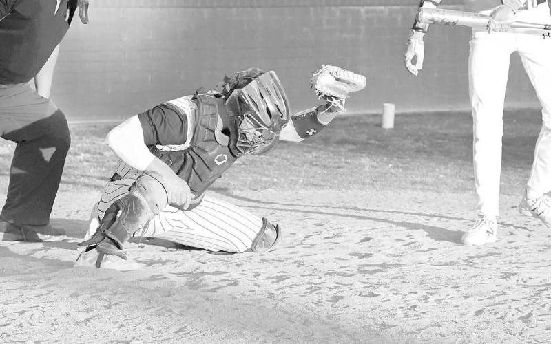 ACTIVE CATCHER- The Levelland Lobos fell behind early and could not come back in a 9-5 home loss to Snyder last Friday. Levelland catcher Rusty Johnson was very active behind the plate. The Lobos traveled to Lubbock Friday to take on Estacdo. A win for the Lobos secures a playoff spot, but a loss would mean the Lobos’ postseason chances would need some help. (Staff Photo by Dom Puente)