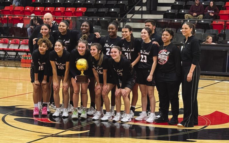 BI-DISTRICT CHAMPIONS - The Levelland Loboettes won over the Brownwood Lady Lions this past Monday night in Colorado City to win the Bi-District round of playoffs. Pictured above are Coach Clay Barnett with his team in Colorado City. (Staff photo by Aalijah Soliz)
