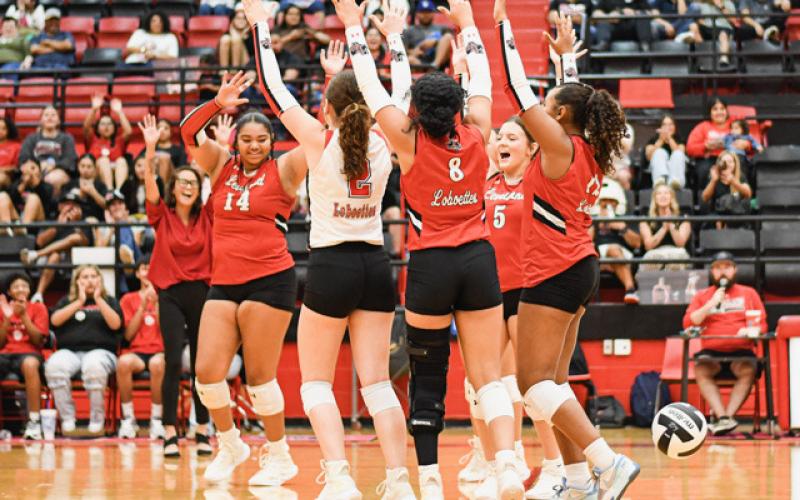 HANDS UP CELEBRATION – The Levelland Loboettes and their Head Coach Jai Madrid celebrate their set win in a match against SA Lakeview this past Tuesday. The Loboettes would go on to sweep them 25-19, 30-28 and 26-24.