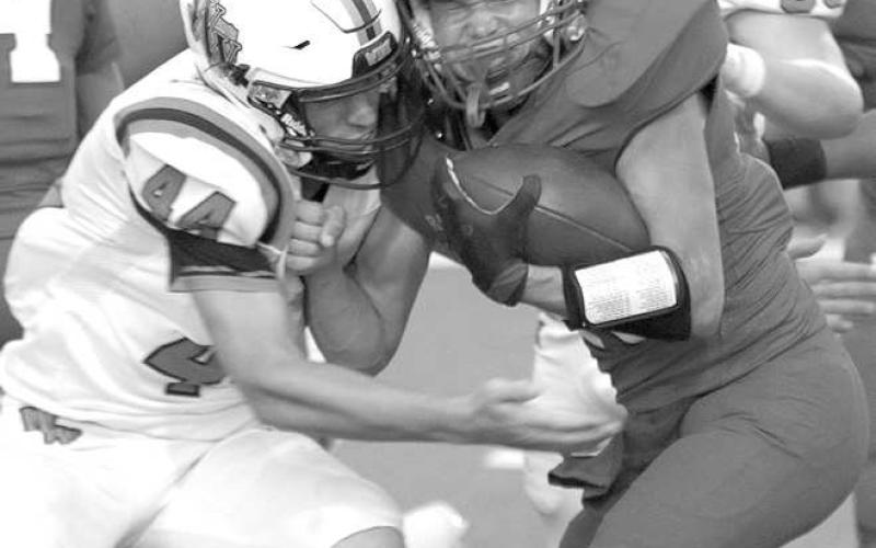 METATTHELINE- Sundown Roughneck Hunter Tindol is met at the line of scrimmage by a Wink defender. The Roughnecks hosted the Wink Wildcats for homecoming and fell, 56-14. Sundown will travel to Roosevelt to play a tough Eagle squad on Friday, September 23rd. (Photo Courtesy of Chris Bratcher)