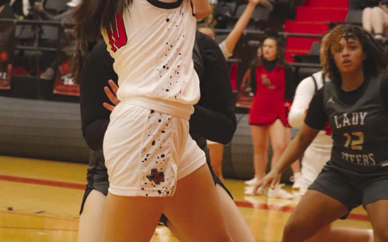 QUICK PASS - Levelland Loboette Emily Perez drove into the paint to look for a quick pass during the team’s game against Big Spring this past Tuesday at home. (Staff photo by Aalijah Soliz)