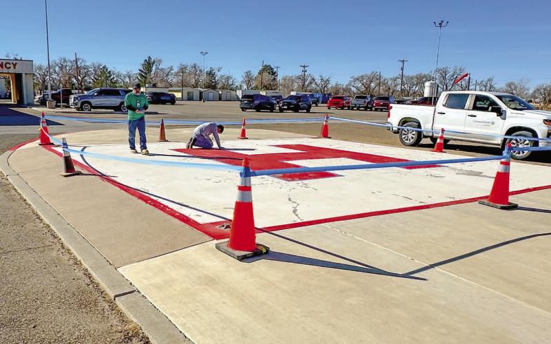 READY FOR LANDING - Senior Facilities Technician, Jerry Escamilla and Facilities Technician, Korey Ellibee for Covenant Hospital Levelland took advantage of the warm weather Monday afternoon by renovating the helipad for future incoming flights. (Photo courtesy of Covenant Hospital Levelland)
