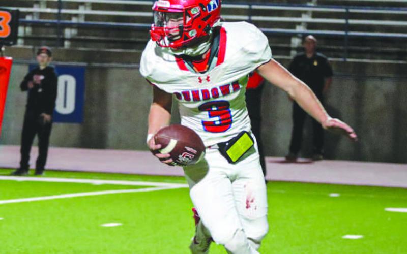 QB SWEEP - Sundown Roughneck Coen Nevarez navigated through traffic this past Thursday on the road in Odessa during the team’s playoff game against Wink. (Staff photo by Aalijah Soliz)