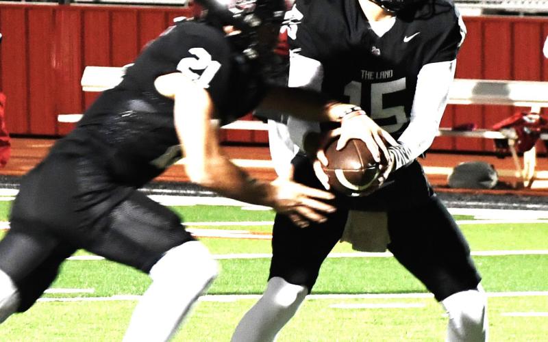 (above) Levelland’s Senior quarterback Ethan Salazar hands the ball to senior running back Jake Potter on Oct. 16 in the 76-53 win over Perryton.