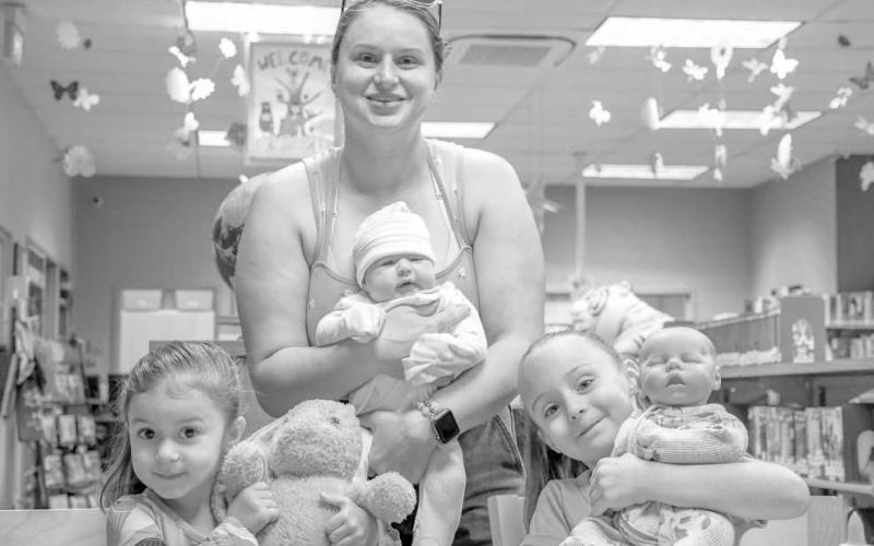 FAMILY FUN - Pictured from left to right are: Maddison, Andrea, and Kelsey Scott who had a fun time as a family during Art and Apples on Wednesday at the Hockley County Memorial Library. (Staff photo by Hannah Woodrum)