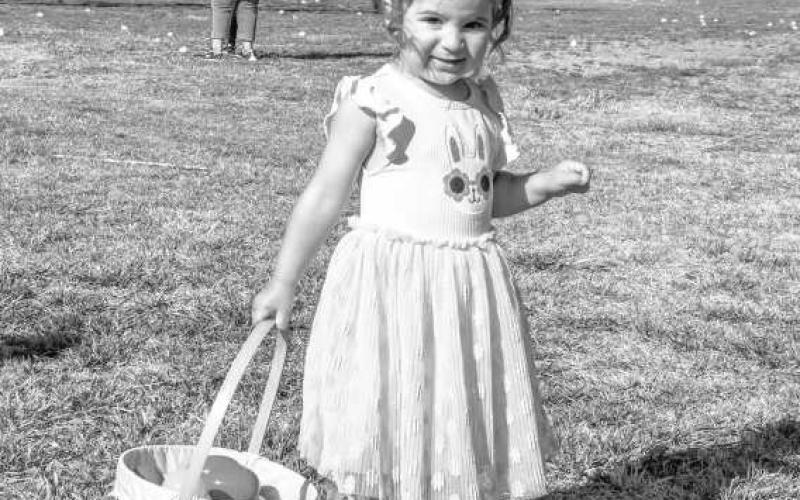 EGG-SPECTING A GREAT EASTER - Amaya Rincones was all smiles while trotting down the bunny trail looking for Easter eggs this past Saturday at the City Park. (Staff photo by Hannah Woodrum)