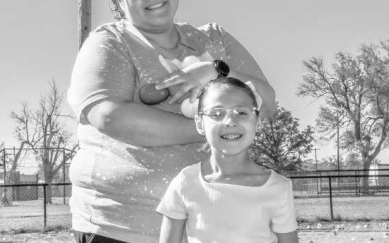 TWO PEEPS IN A POD - Brandie and Marisella Gaona got a sugar rush while searching for Easter eggs this past Saturday at the City Park. (Staff photo by Hannah Woodrum)