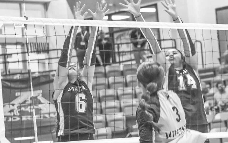 BLOCK PARTY - Levelland Loboettes Hailiee Estrada and Trinity Wafers got vertical to block the shot from the Andrews offense this past Tuesday on the road. (Staff photo by Aalijah Soliz)