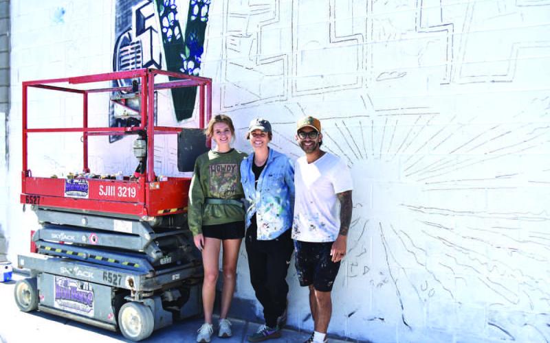 MURALARTIST-- Artists Lexi Antonick, Calina Mishay and Daniel Andreu completed the new mural near downtown this past weekend bringing their talent and color to the City of Mosaics. Located at the corner of Ave. F and Houston St. the vibrant new mural depicting the city and region came to life this past week just as the Centennial Celebration is about to gear up. (Staff photo)