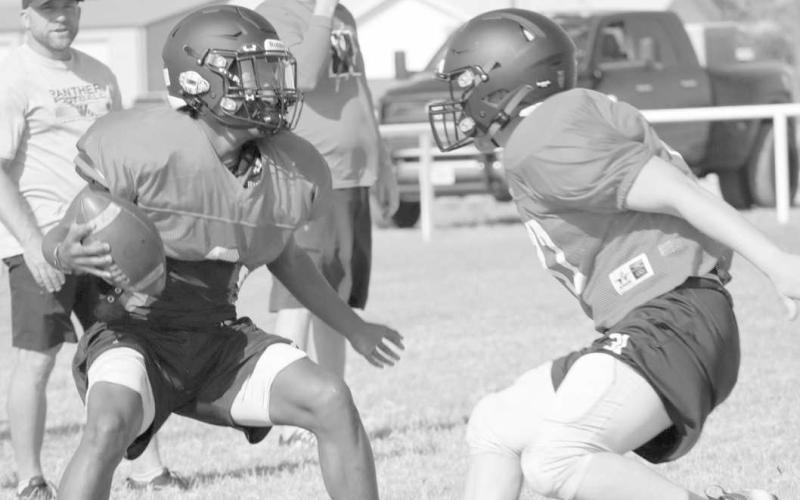 JUKE MOVE - Whitharral athlete Brent Robinson put a move on his teammate during two-a-day pracitces to get past him. (Staff photo by Aalijah Soliz)