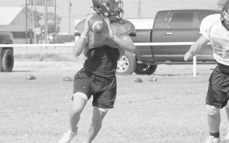 IMPROVISE - Whitharral athlete Brolin Kennedy rolled out for the pass during team practices during twoa- days training. (Staff photo by Aalijah Soliz)
