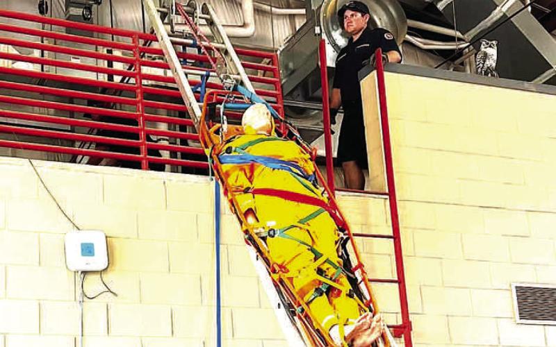 LADDER DRILLS - Levelland Fire Department practices moving a patient up or down a ladder on a stretcher, a procedure called a ladder slide, ladder pivot rescue, or hinge rescue. The patient is secured in a rigid basket stretcher rather than a standard wheeled gurney, and is raised or lowered using a specialized rope and pulley system. (LFD photo)