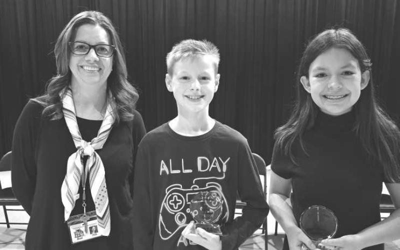 DISTRICT SPELLING BEE- LMS 5th-Grader Caleb Willey won the Levelland District Bee by spelling the word “composition”. The Bee included students from Capitol and South as well. The Bee went for 10 rounds. The Runner-Up was LMS 6th-Grader Katherine Bunker. Willey will continue on his spelling journey and compete in the Regional Bee in Lubbock in March. Pictured are: LMS Bee Coach Mixie Clowe with Caleb Willey and Katherine Bunker. (Photo submitted by Cristal Isaack)