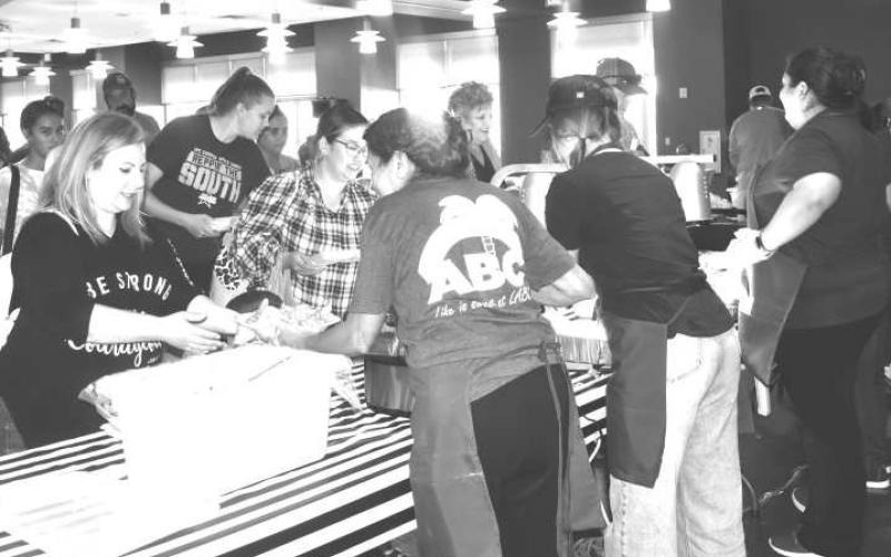 COME AND GET IT- The Levelland Christian Schools’ Annual Fish Fry event and volunteers had food and drinks ready to serve Thursday at the Mallet Event Center. Community members eagerly awaited for their turn as the group saw a successful turnout for the event. (Staff photo by Emily Campos)