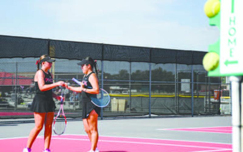 DAP IT UP – Teagan Brothers and Madison Almager dap it up after scoring a point in their double's matchup against Big Spring at the Levelland Tennis Courts on August 2. (Staff photo by Jentezen Smith)