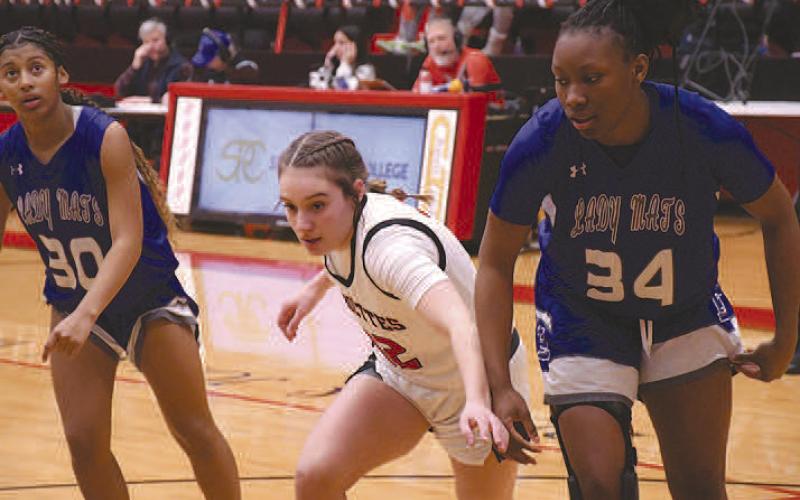 BLOCK OUT- In a nail-bitter of a matchup against the Estacado Lady Matadors, the Levelland Loboette basketball team secured their third straight district championship, 57-51, in overtime. Loboette Emery Smith blocked on a free-throw attempt. (Staff Photo by Dom Puente)