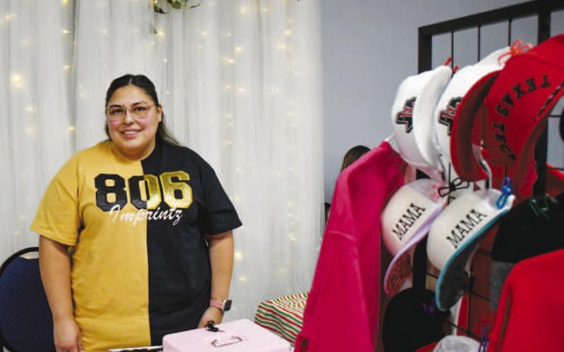 MERCH STAND – Cassandra Salinas was set up inside of Studebaker Event Center, selling clothes and accessories to Ladies Night Out attendees on Thursday night in Levelland. (Staff photo by Evin Thomas)