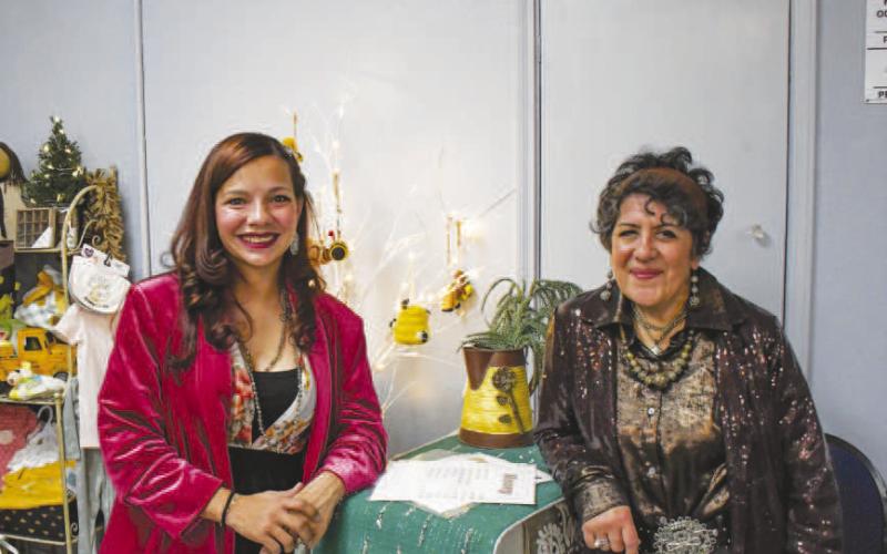 STUDEBAKER SHOPPING – Shelby Guajardo and Christie Mitchell smiled at their bright, colorful setup in Studebaker Events during Thursday nights Ladies Night Out in downtown Levelland. (Staff photo by Evin Thomas)