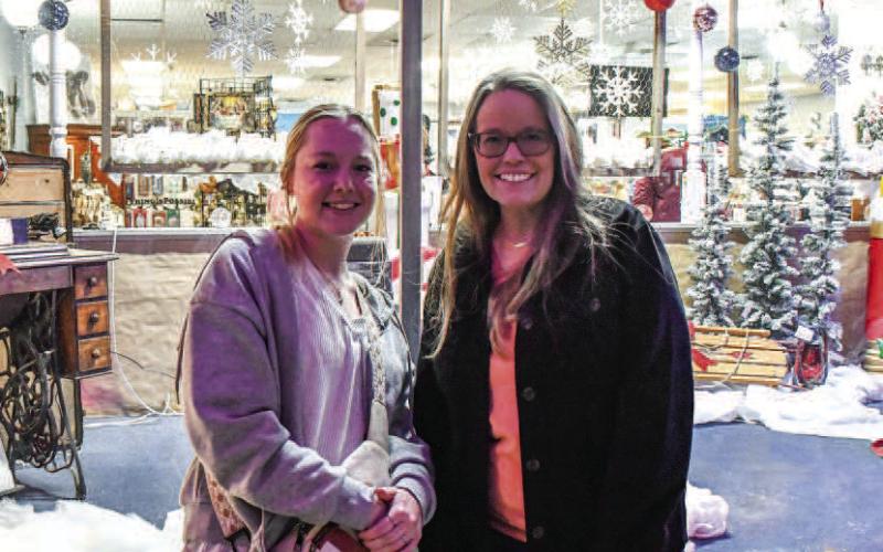 CHRISTMAS BACKDROP – Wyndy and Caylee stood and talked alongside the downtown Levelland square during Thursday nights Ladies Night Out event. (Staff photo by Evin Thomas)