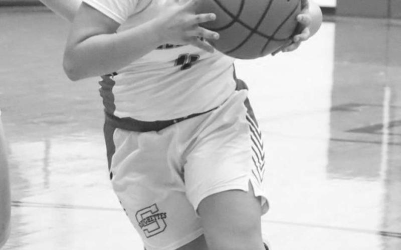 DRIVE IN - Sundown Roughette Yaya Lopez drove the ball in the middle of the New Home defense last Tuesday during their district opener. (Staff photo by Aalijah Soliz)