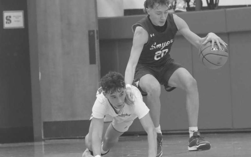 DIVINGATTEMPT - Smyer Bobcat Mason Medart was able to hold onto the ball with Sundown Roughneck Coen Navarez making a diving attempt to steal the ball during the team’s district matchup with each other in Sundown. (Photo courtesy of Sundown ISD)