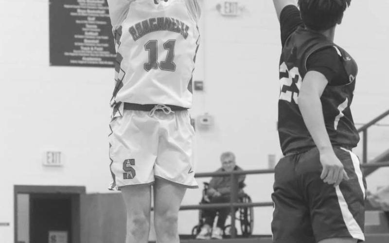 THREE POINTER - Sundown Roughneck Kye Powell shot the ball from long range with Smyer Bobcat Austin Martinez going to conteset the shot. (Photo courtesy of Sundown ISD)
