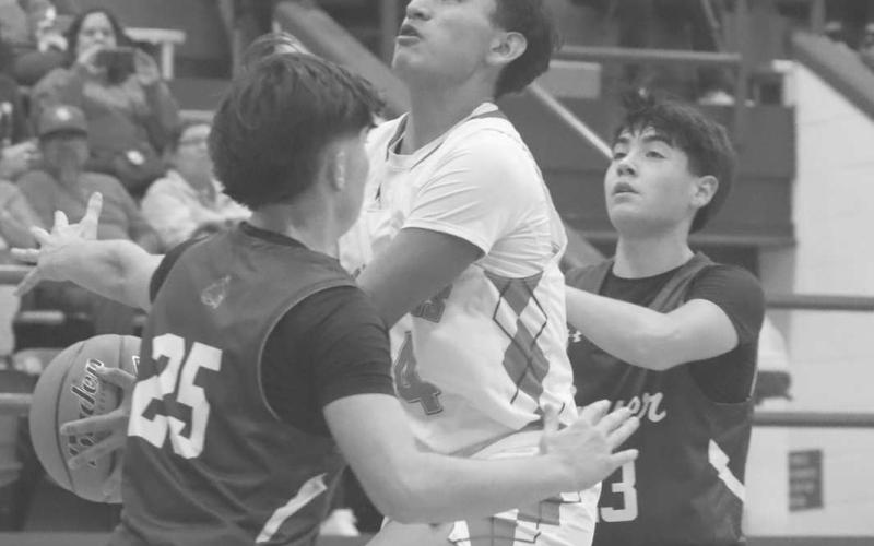FOCUSED - Sundown Roughneck Isaac Lopez was focused on scoring with Bobcats Skyler Pond and Austin Martinez contesting the shot during the team’s district matchup in Sundown. (Photo courtesy of Sundown ISD)