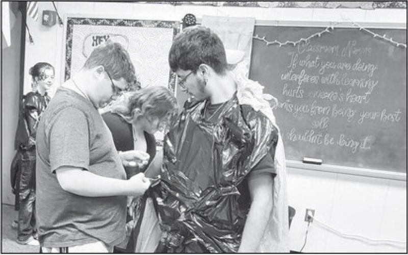 TRASH TO TREASURE: LHS Theater Department designed costumes in Miss Ashley Peikart's class. Students completed their trash to treasure costumes and held a fashion show for several classes. The activity helped students learn the importance of costumes in the theatre world. Pictured in the back are Adisyn Strickland, far left Able Franco, Kendra Karnes in the middle, and Damion Reyes on the right. (Photo submitted by Cristal Isaacks)