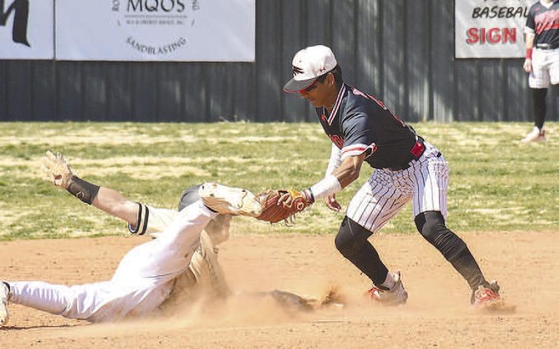 TAG- Levelland Lobo defeated Bushland at home Monday afternoon, 7-5. Pictured is Lobo Noah Tienda tagging a Bushland runner. Levelland will host Tulia Tuesday, March 21st. (Staff Photo by Dom Puente)