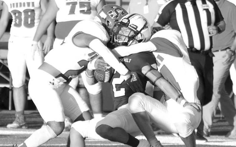 COMBO TACKLE- The Sundown Roughnecks traveled to Acuff to face the 3A Roosevelt Eagles on Friday night and left with a three point loss 26-29. Adan Escamilla and Riccky Melendez combine for a defensive stop. The Roughnecks have a bye this week and will return to the field for their district opener in Floydada October 7.(Photo Courtesy of Chris Bratcher)