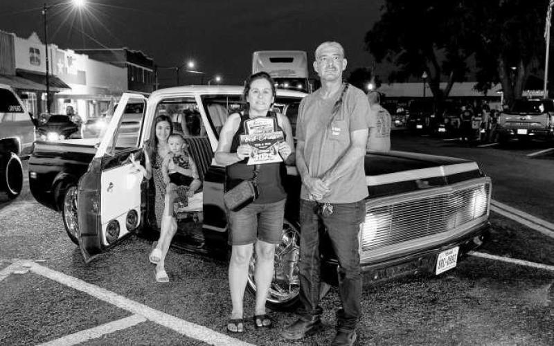 CRUISE WINNER - Pictured is Marry and Jerry Gonzales with Lind after receiving an award during the Thunder on the Plains Cruise. (Photo courtesy of J. Conrad Photography)