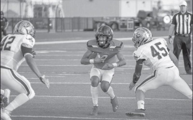 BRACE - Levelland quarterback Boston Winfield braced for the hit as two Lubbock High Westerner defenders closed in for the tackle during last Friday’s win. (Staff photo by Dom Puente)