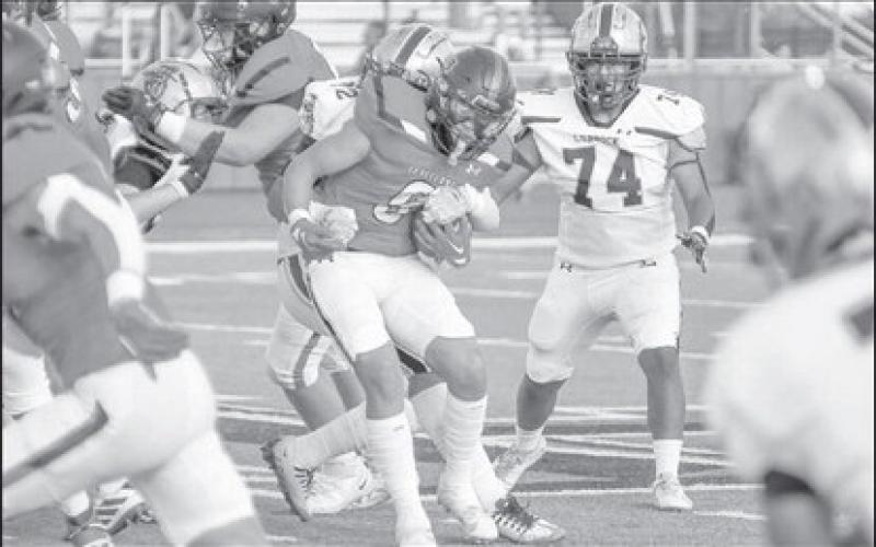 BALANCE - Levelland wide receiver Kaden Brogden tried staying up as he was dragged down by a Lubbock High defender for a few extra yards. (Staff photo by Dom Puente)