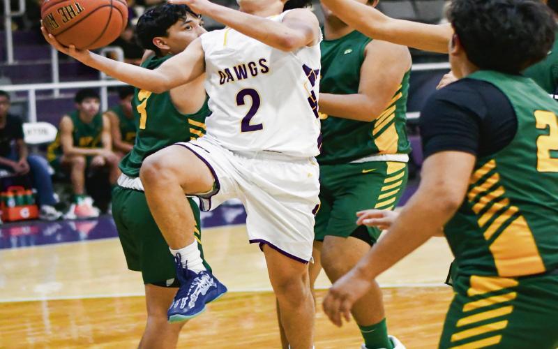 ALAFA SPLITS THE DEFENSE - Anton’s Isaiah Alafa splits four Springlake-Earth defenders during their game this past Friday night in Anton. (Staff photo by Jentezen Smith)