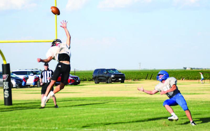 ONE-HANDED PICK – Senior outside linebacker Damian Rodriguez made a one-handed interception during a scrimmage Friday against the Lubbock Titans and Nazareth. (Staff photo by Jentezen Smith)