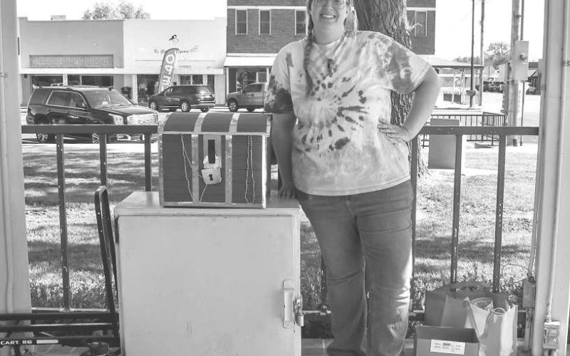 TRESURE CHEST- The Hockley County Library Summer Program had a tresure hunt on Wednesday at the Hockley County Court house lawn. The tresure chest was made possible by the Hockley County Memorial Library. Pictured is the Library Clerk Shawna Carpenter Lopez. (Staff photo by Emily Campos)