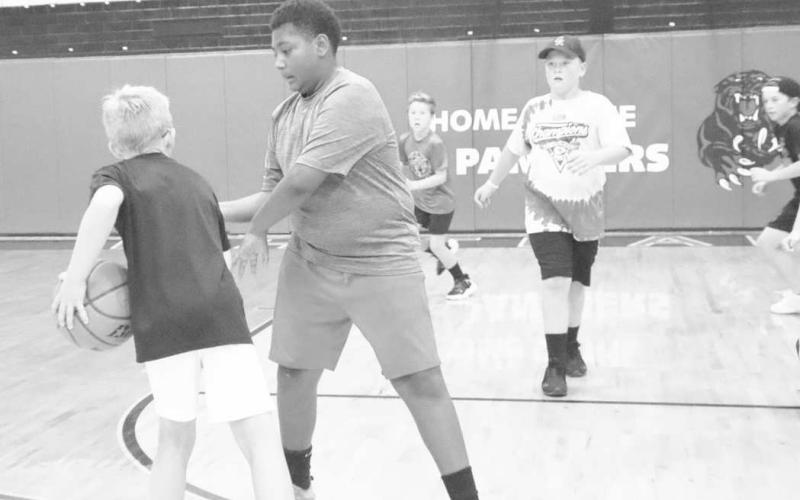 DEFENSE - Whitharral students Brashon Robinson and Brady Holt went head-to-head during the basketball portion of camp at the Whitharral All-Sports Camp this week. (Staff Photo by Aalijah Soliz)