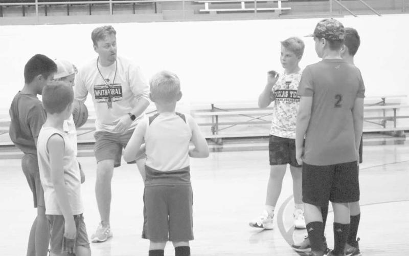 LIKE THIS - Head Coach Matt White taught the kids attending the Whitharral All-Sports camp how to properly complete the next drill during the basketball portion. (Staff Photo by Aalijah Soliz)