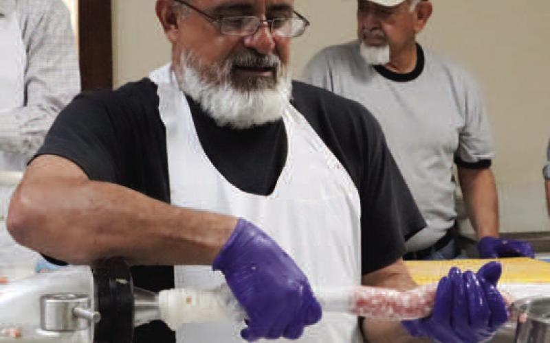HOW THE SAUSAGE IS MADE - Pictured is Ray Rodriguez helping tube the sausage Friday at St. Michael’s Catholic Church. The 40th Annaul Sausage Lovers Festival will be held Sunday, Feb. 16. (Staff photo by Adriana Solis)
